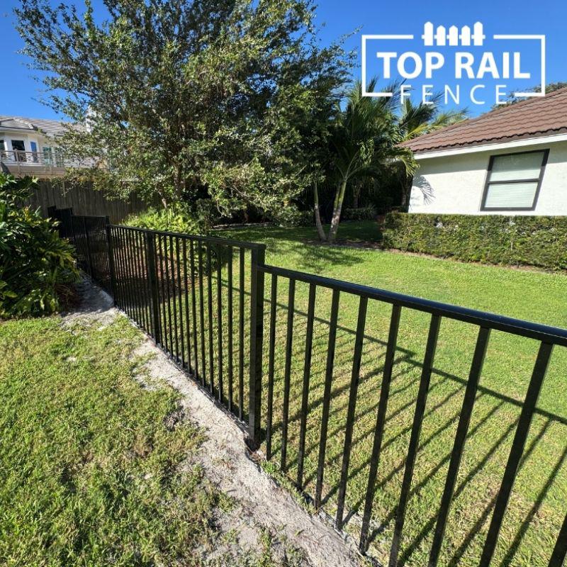 ornamental metal fence installed by top rail fence