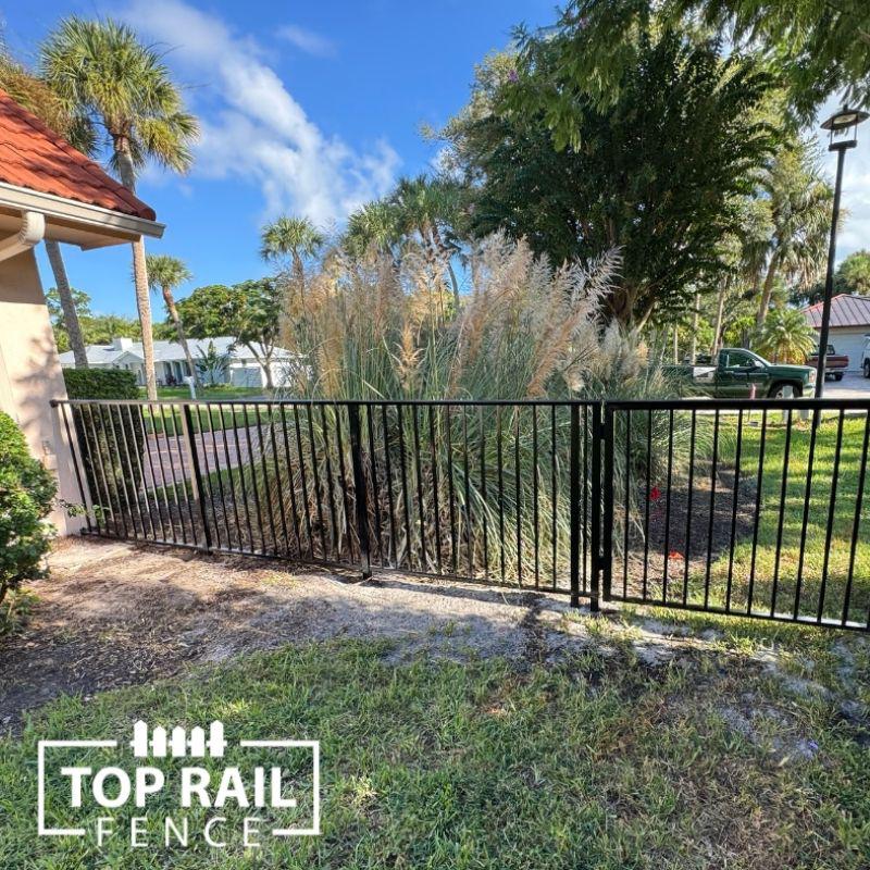 ornamental metal fence installed by top rail fence