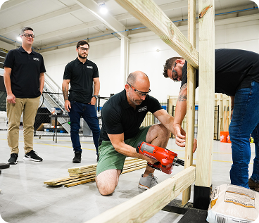 Top Rail team member assembling a fence on-site