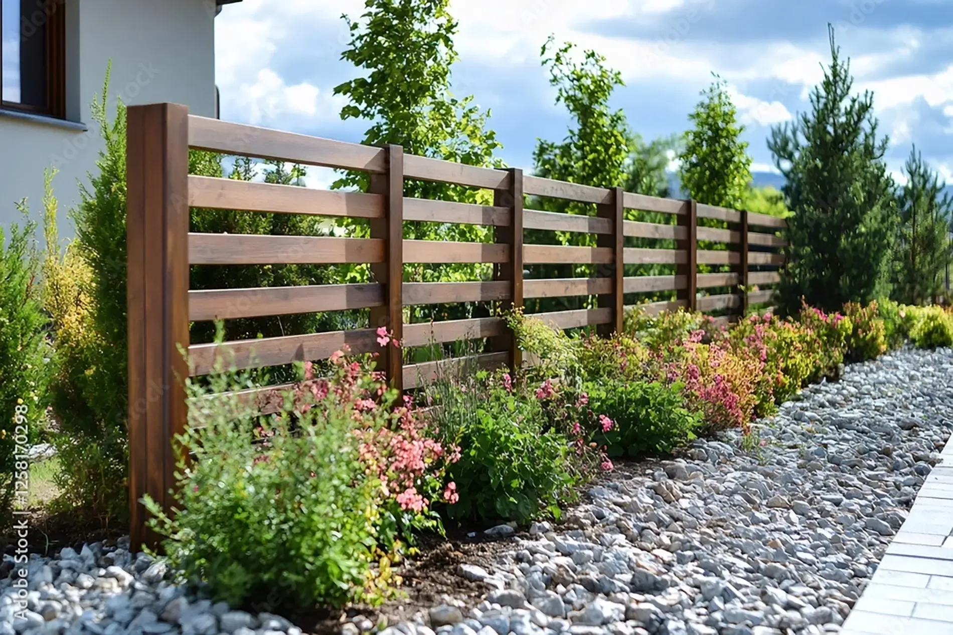 Dog standing in front of a metal fence