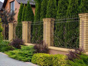 wrought iron fence with brick pillars