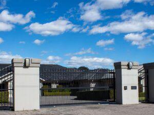 Wrought iron fence with stone pillars
