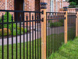 Wrought iron fence with wood posts