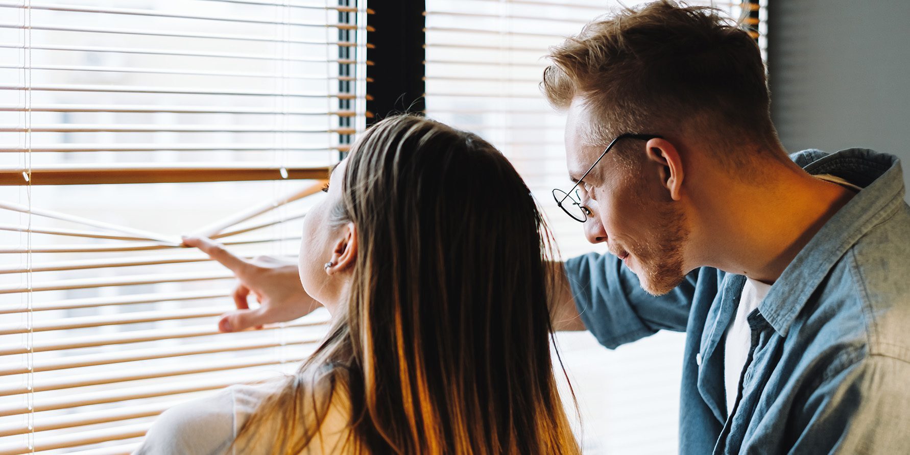 Couple looking out their window