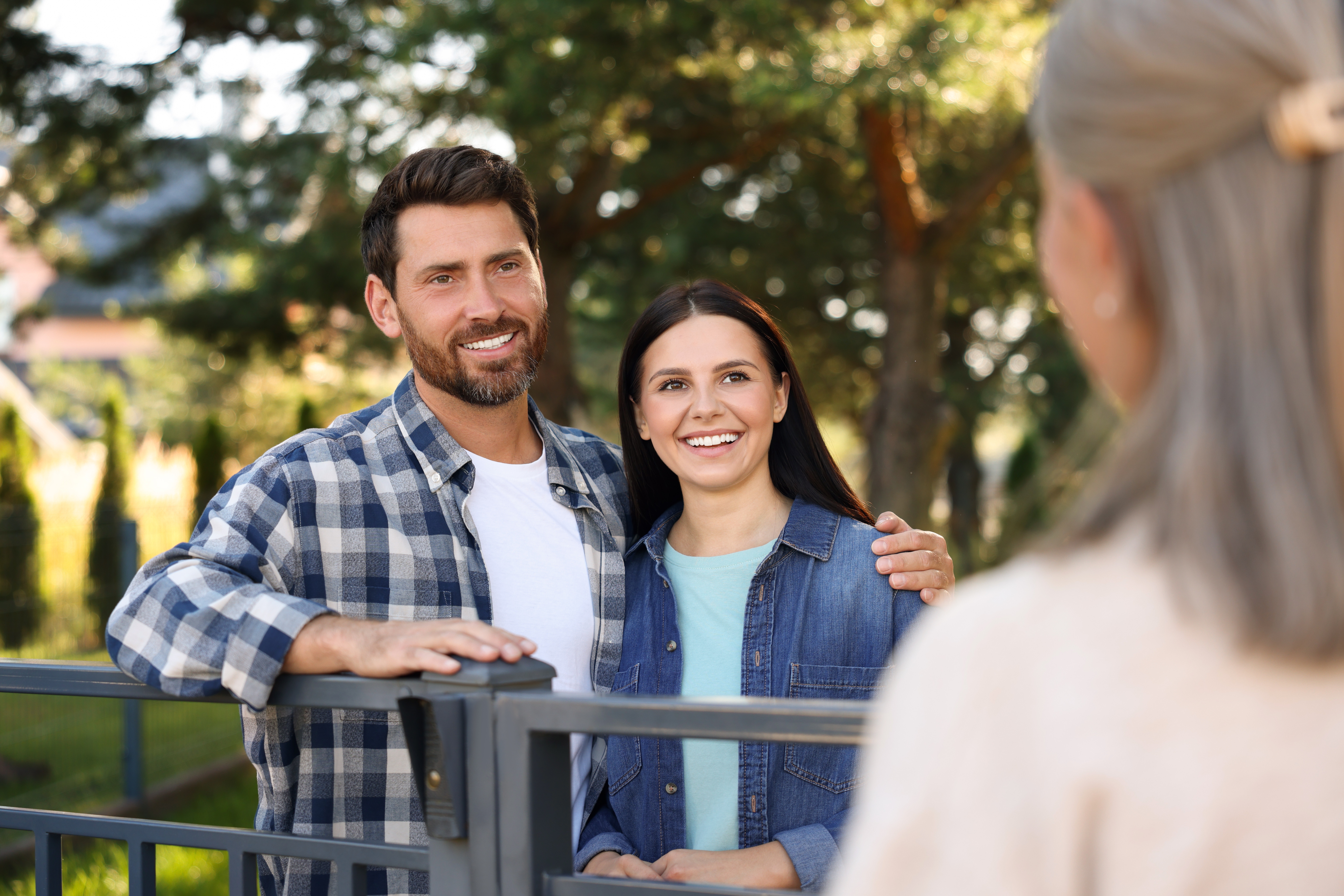 Neighbors talking over a fence
