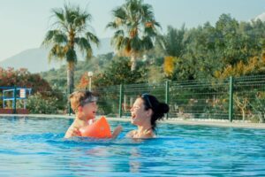 mom and child swimming in a pool