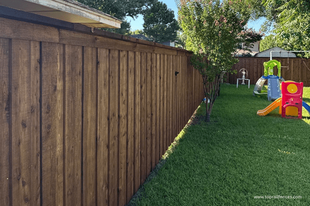 Custom board on board fence installed by Top Rail Fence in backyard setting