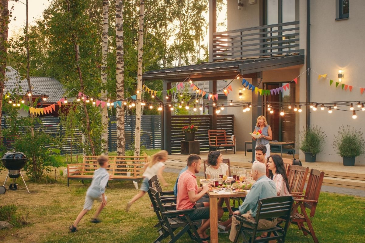 social gathering in a nice backyard with horizontal fencing and railing