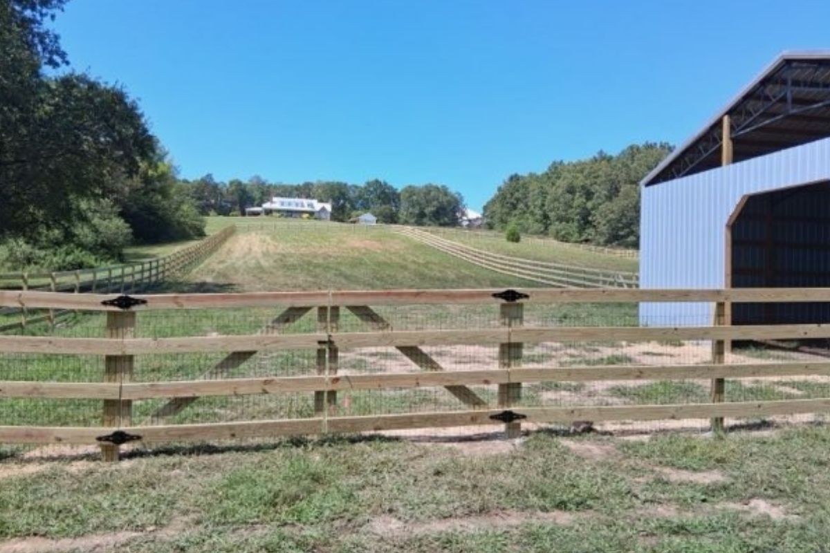 a 4-Rail Ranch Style Fence installed by Top Rail Fence