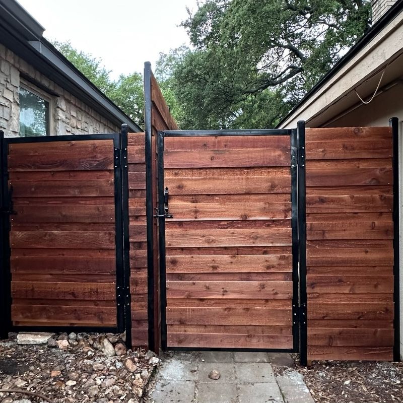 horizontal dark stained wood fence with black metal reinforcements