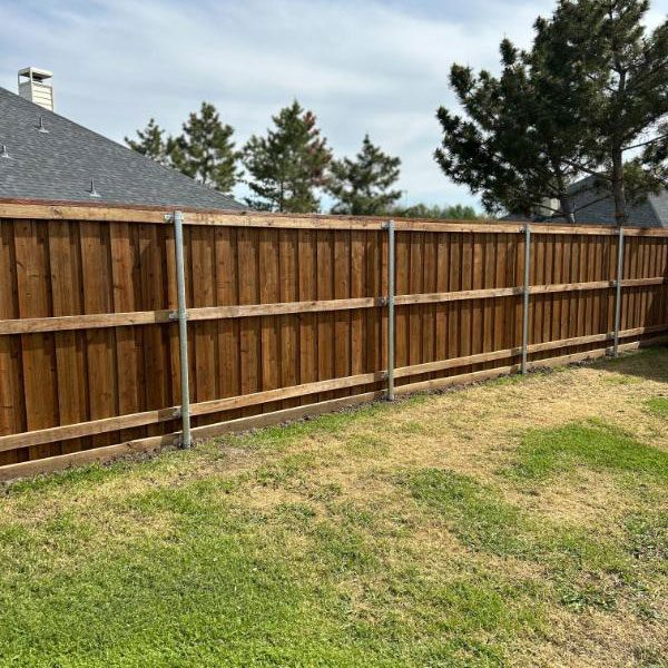 backyard Wooden Top Rail Fence in North Dallas