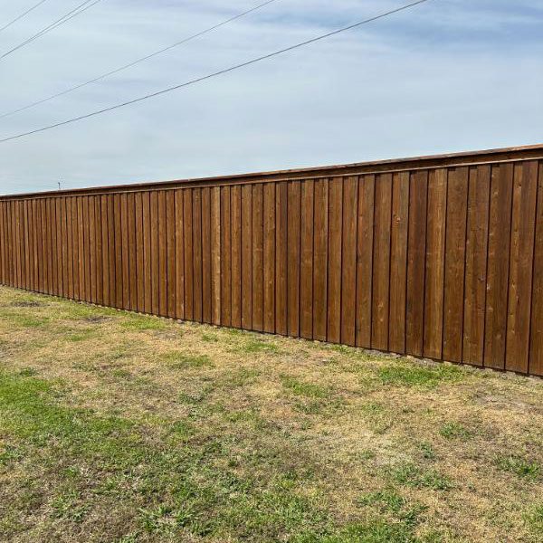 Backyard brown Wooden Top Rail Fence in North Dallas