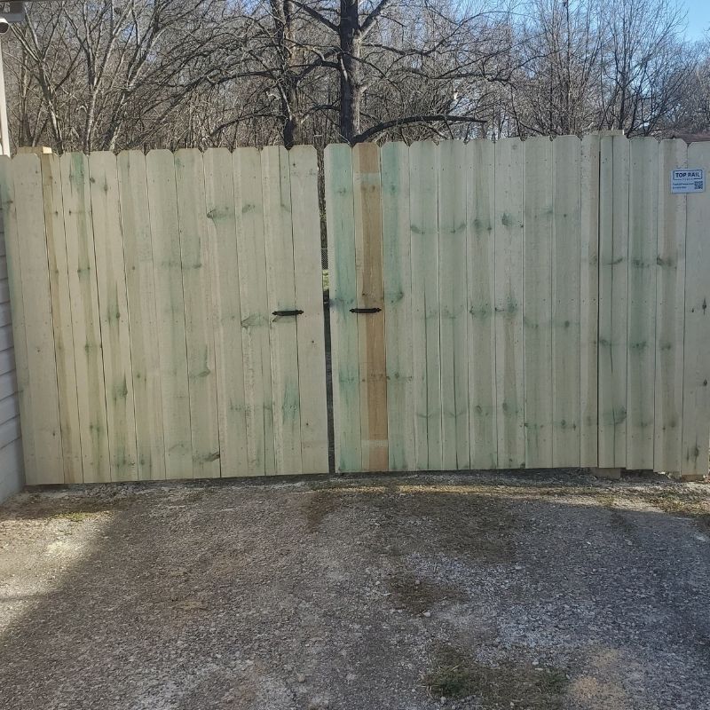 Pressure treated pine stockade fence installed by Top Rail Fence