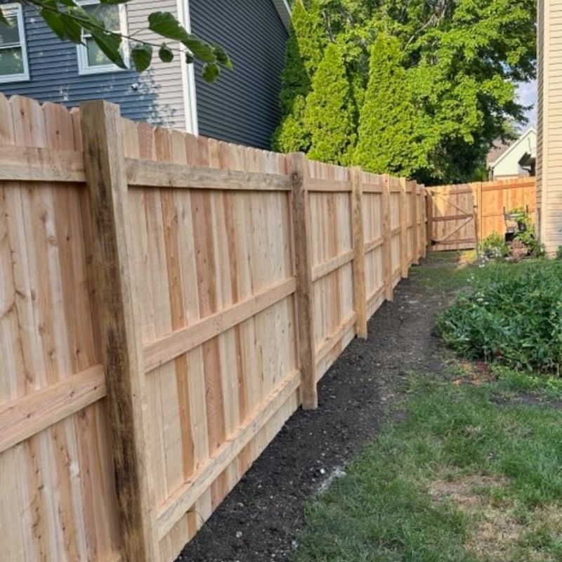 stockade fence installed by top rail fence