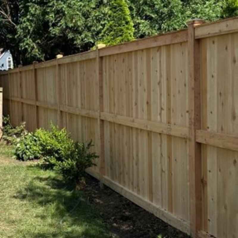 stockade fence installed by top rail fence