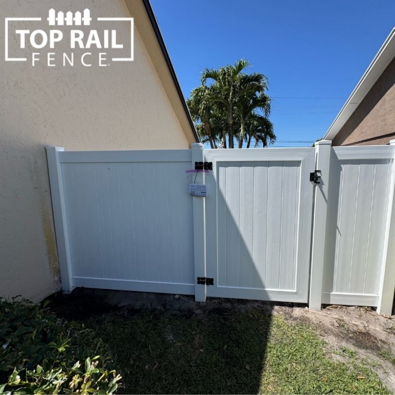 white vinyl fence and gate installed by Top Rail Fence