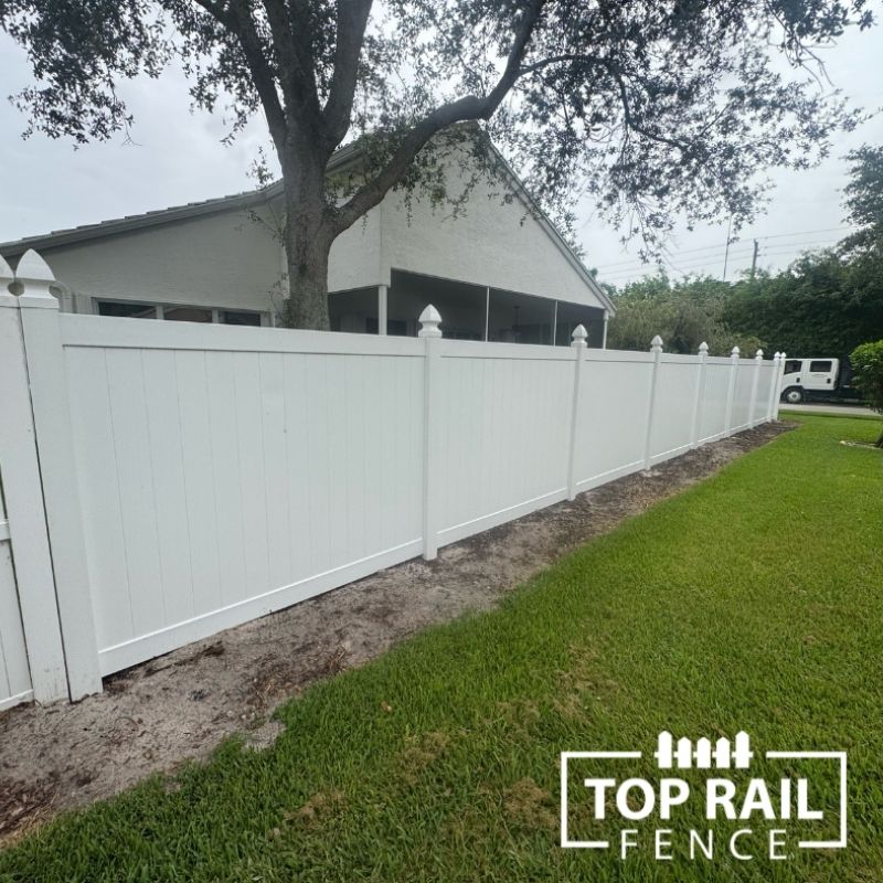 white vinyl fence installed by top rail fence