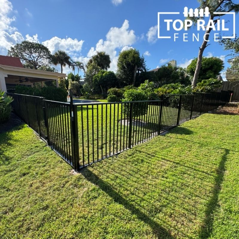 ornamental metal fence installed by top rail fence