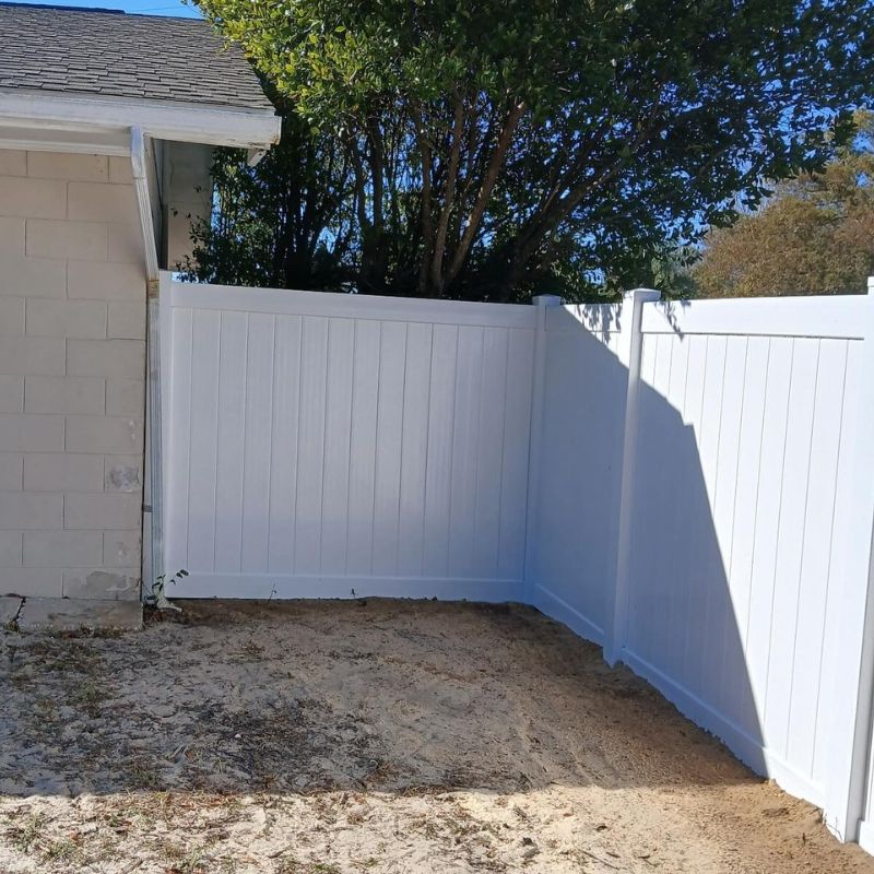 White vinyl fence connected to a home