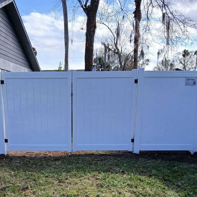 White vinyl fence with double gate