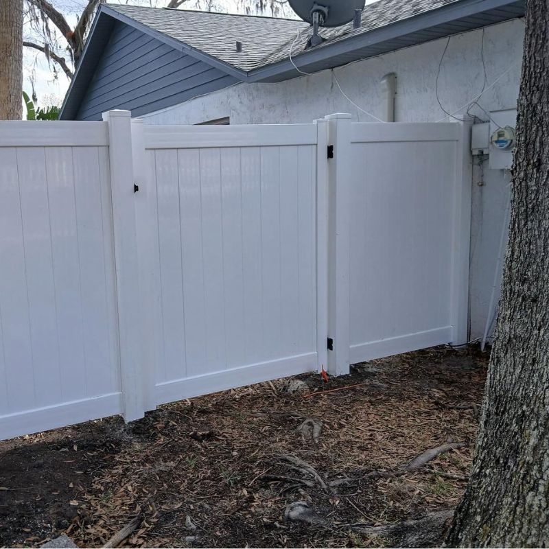 white vinyl fence attached to house