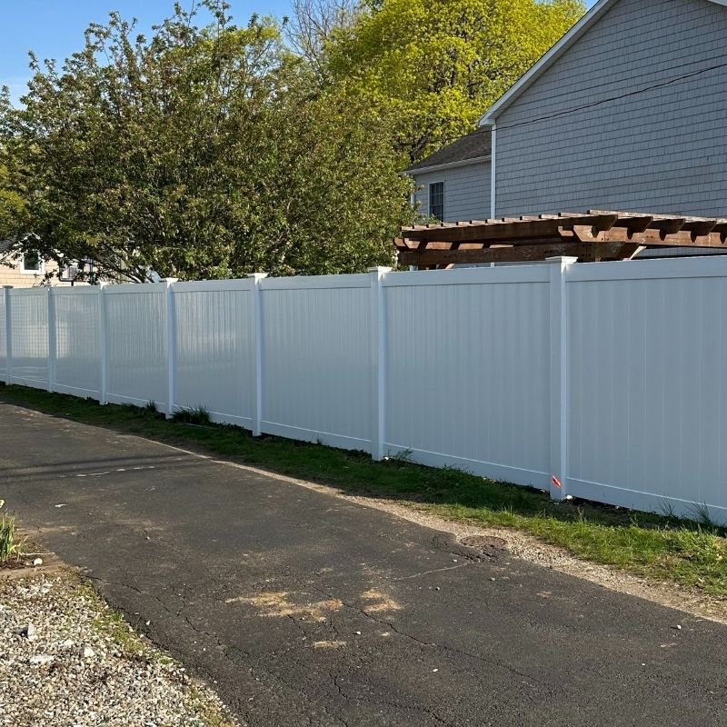 White vinyl privacy fence installed by Top Rail Fence