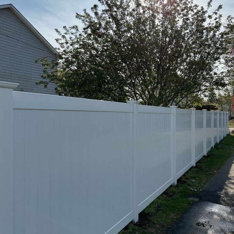 White vinyl privacy fence installed by Top Rail Fence