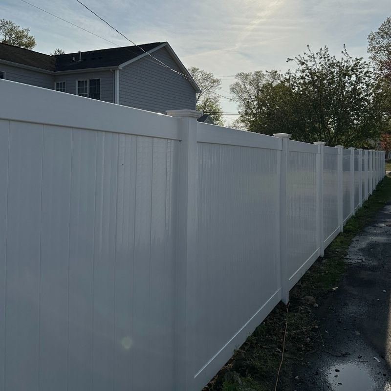 White vinyl privacy fence installed by Top Rail Fence