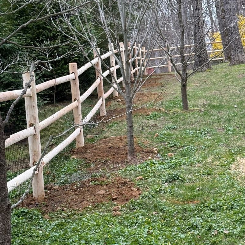 cedar round post and rail fence with heavy duty welded wire installed by Top Rail Fence