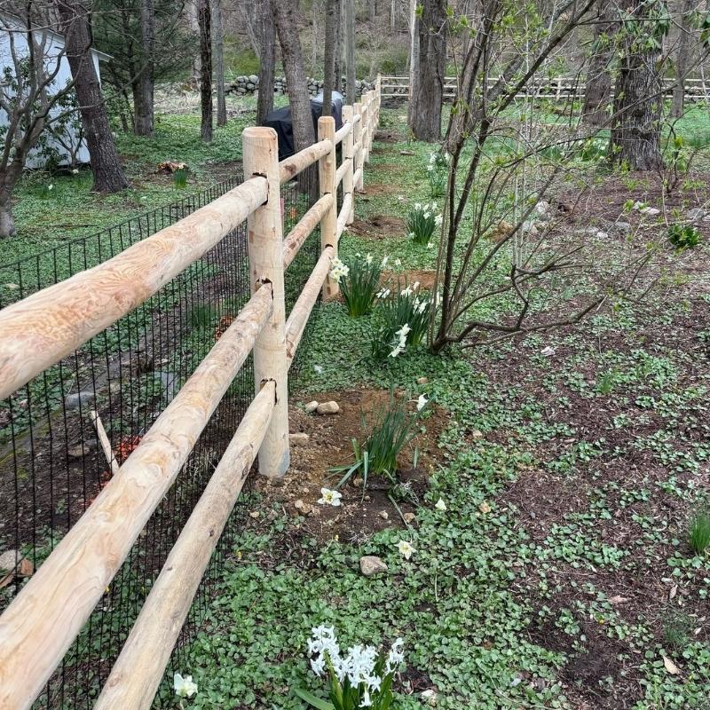 cedar round post and rail fence with heavy duty welded wire installed by Top Rail Fence