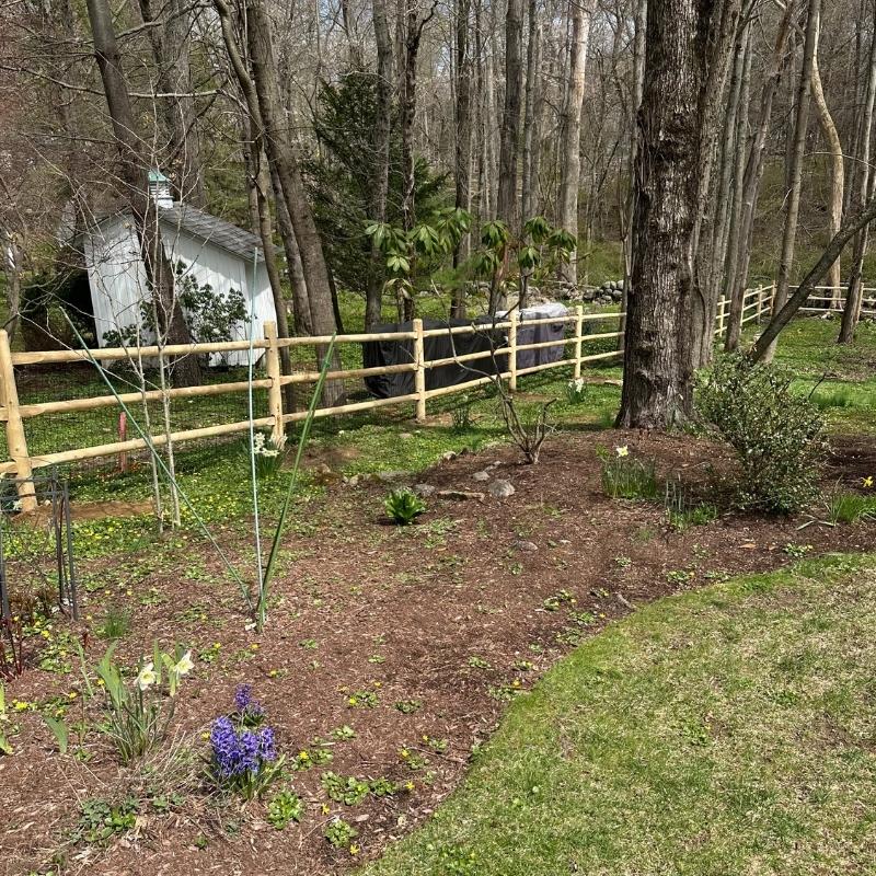 cedar round post and rail fence with heavy duty welded wire installed by Top Rail Fence