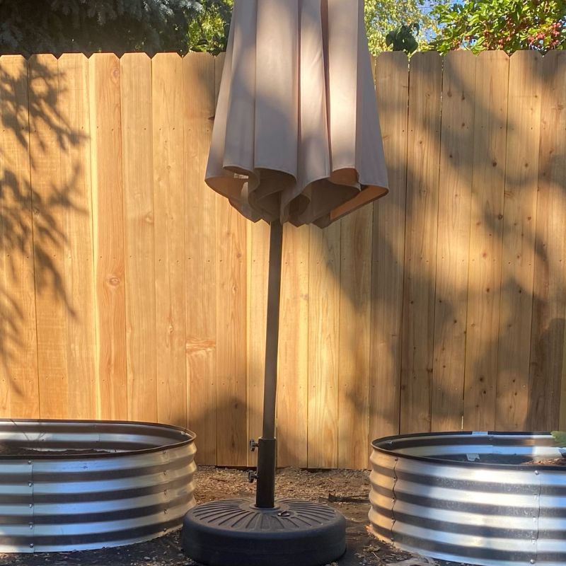 New wood fence with umbrella and metal planters