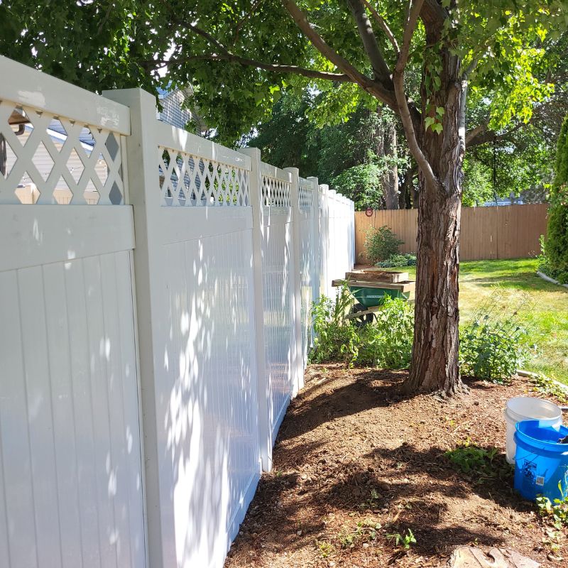 Close up of white vinyl fence