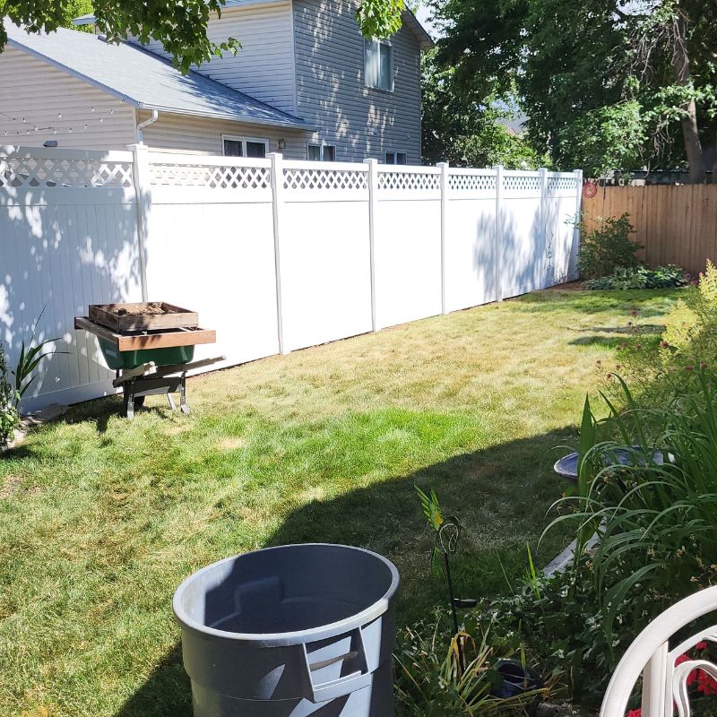 White vinyl fence in backyard