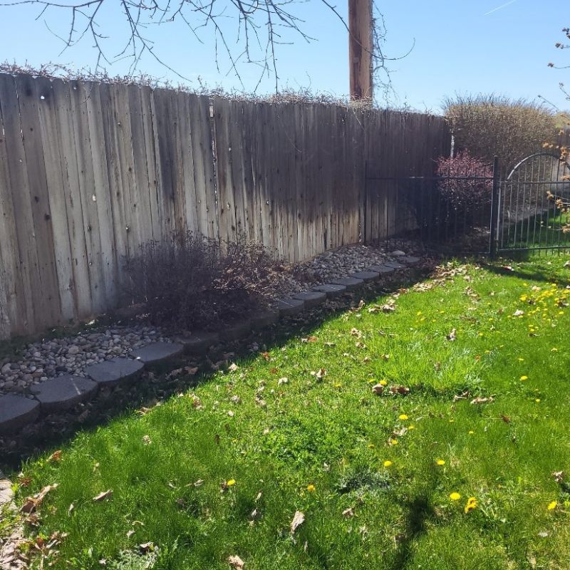 Older wood fence with landscaping