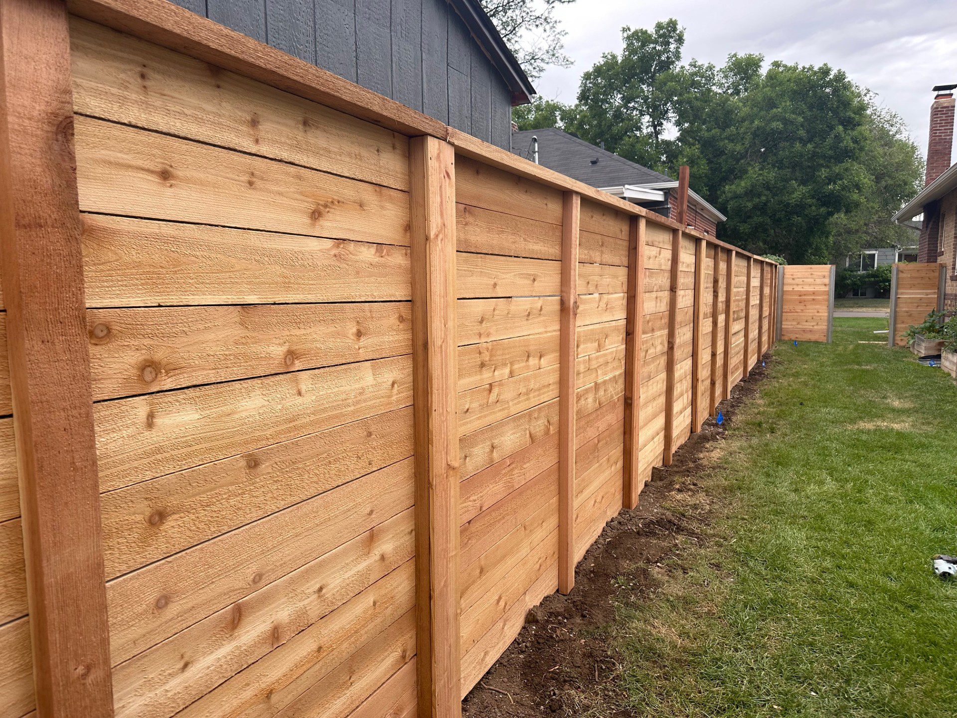 Wood privacy fence installation in Denver, CO