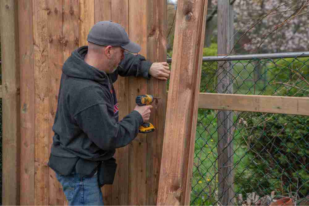 man building his own fence