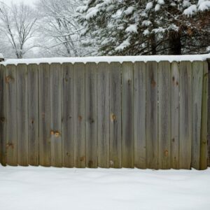 wood fence with snow during winter time