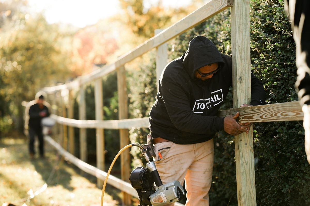 Top Rail Fence technicians installing a wood fence