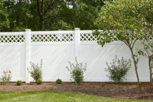 white vinyl fence with landscaping