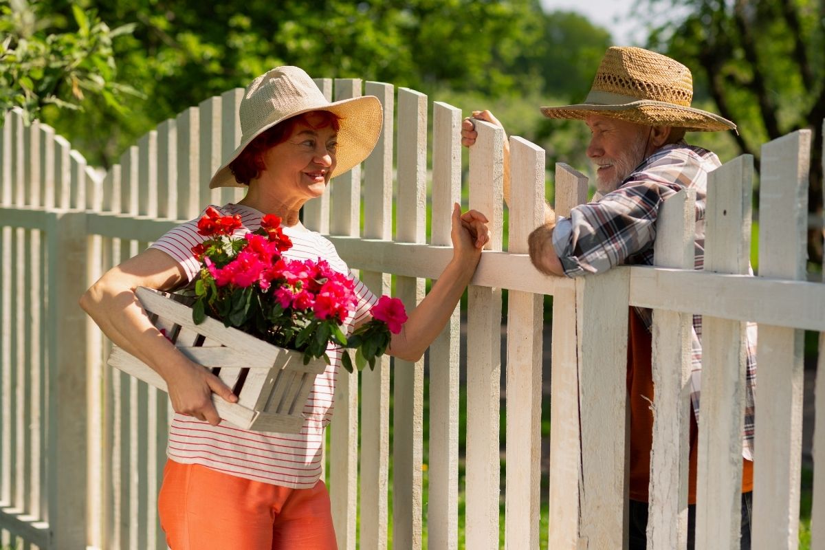 Neighbors talking at the fence line