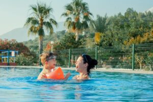 mom and child swimming in a pool