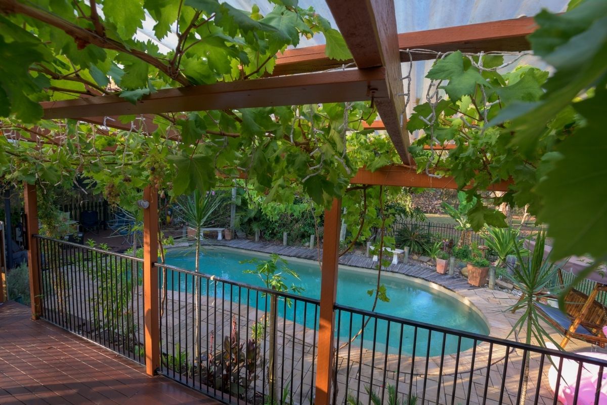 Wood and ornamental metal fence around a residential pool