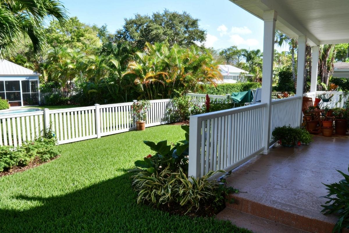Backyard with white picket fence and porch in Florida