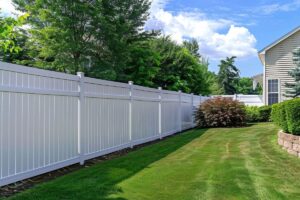 Vinyl fence and side of house view from the backyard.
