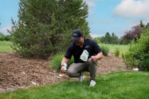 Top Rail Fence employee marking the fence line.