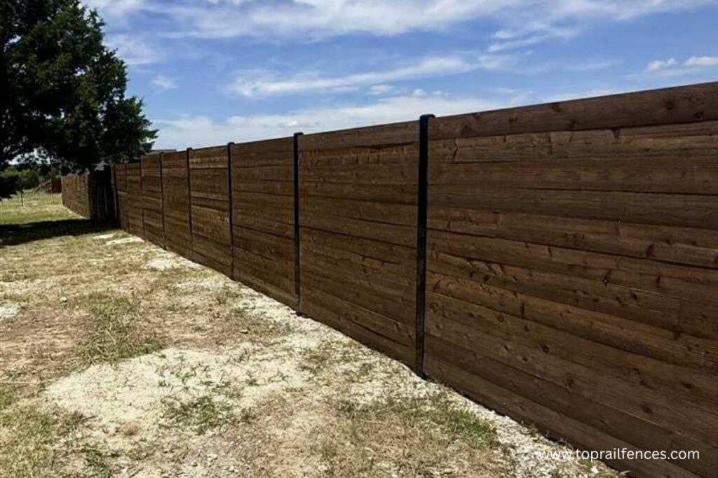 Horizontal dark stained wood fence installed by Top Rail Fence