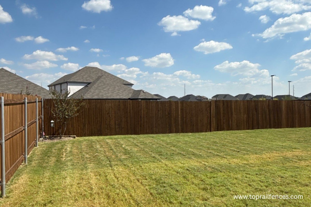 stained Wood fence installed in a backyard by Top Rail Fence